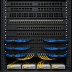 Network rack with patch panels and neatly bundled cables in a comms room